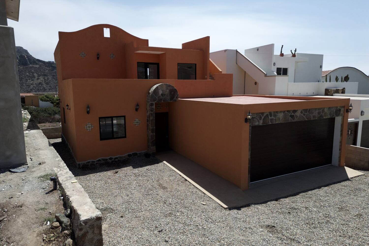 La Misión 301 — hacienda-style front elevation and two-car garage from above