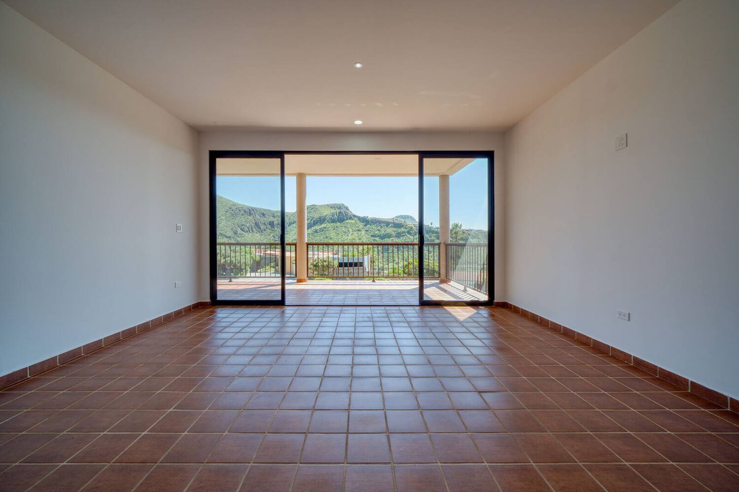 Open living and dining area with sliding glass doors to the terrace