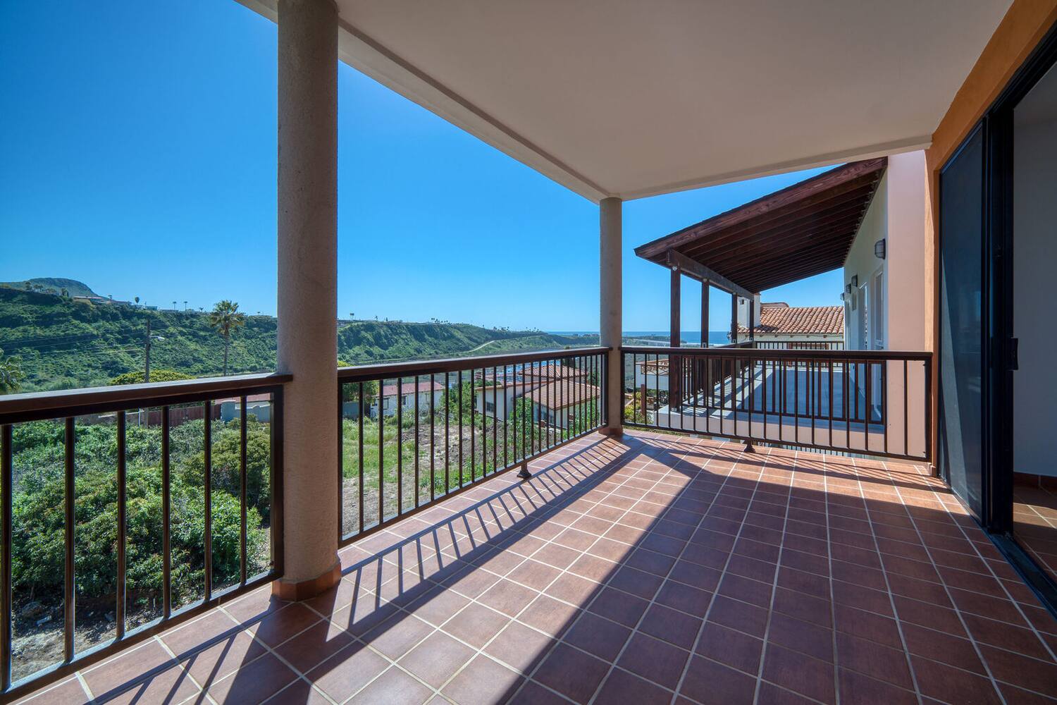Upper-level terrace under the wooden roof at La Misión 301