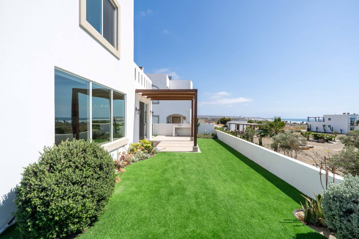 The backyard lawn at Villas Punta Piedra #49, ocean on the horizon